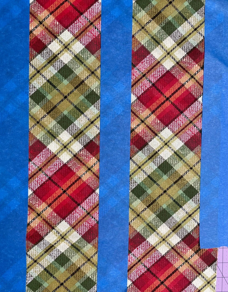 plaid fabric with 3 strips of blue painters tape