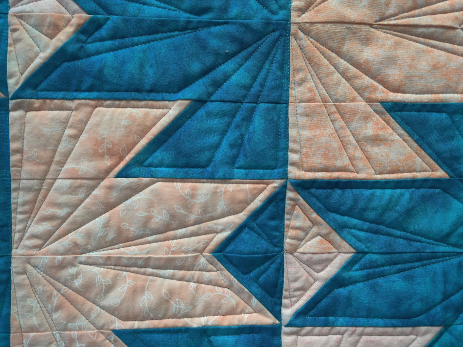 Quick Quilts 2023 – Delectable Mountains - Win our finished quilt - zoomed in view of turquoise and peach threads