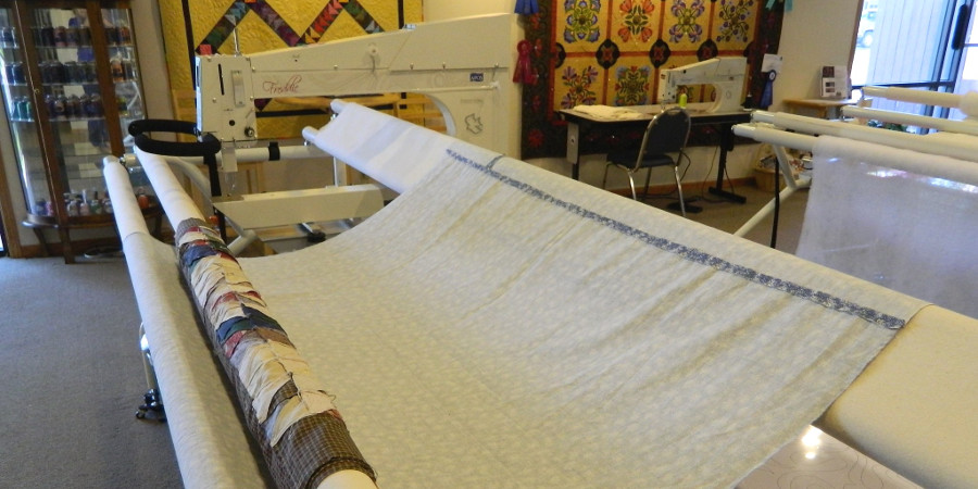 Loading a quilt on your longarm quilting machine - a quilt top loaded onto an APQS machine