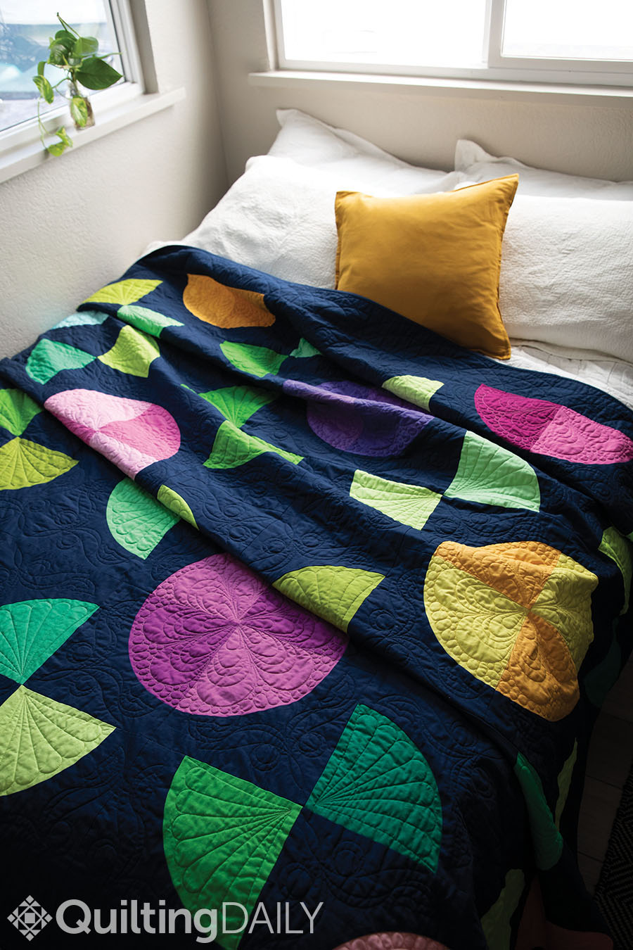 Free quilt pattern: Drunken Flowers - quilt displayed as a comforter on a bed