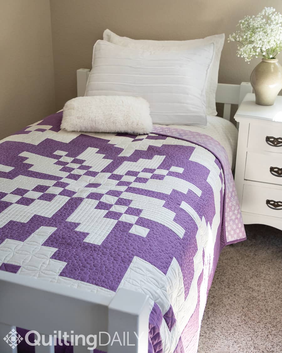 Free pattern: Snow Blossom - quilt pattern displayed on a bed