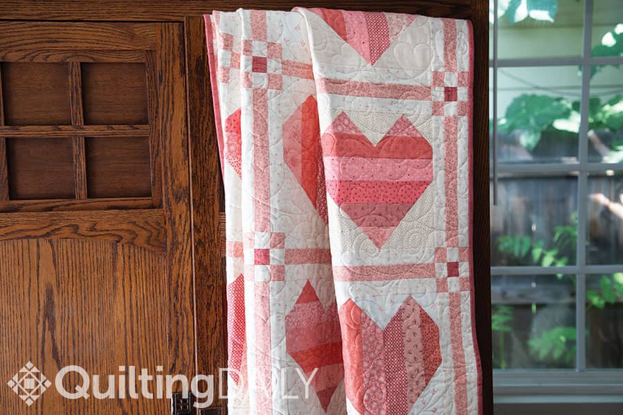 Free pattern: Change of Hearts - quilt pattern displayed on a door