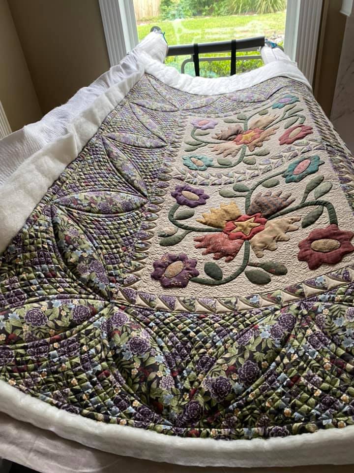 How to take high-quality photographs of your quilt - image of floral quilt on display with natural lighting